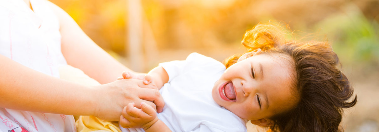 Picture of a toddler playing with an adult, illustrating emotional intelligence for kids