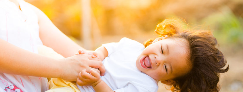 Picture of a toddler playing with an adult, illustrating emotional intelligence for kids