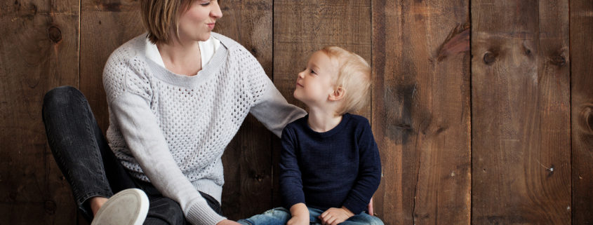 What is Positive Parenting? photo of a young boy in his mother's lap